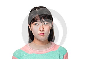 Studio portrait of a teenage East Asian woman looking sideways