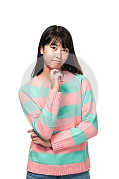 Studio portrait of teenage East Asian woman thinking