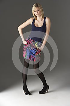 Studio Portrait Of Teenage Girl Standing In Studio