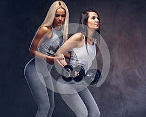 Studio portrait of two sporty women.