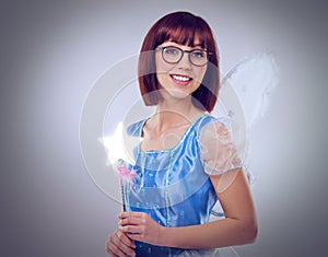 Studio, portrait and woman as fairy for magic, happiness and looking at wand for fantasy in background. Adult, female