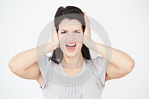 Studio Portrait Of Woman Covering Ears With Hands