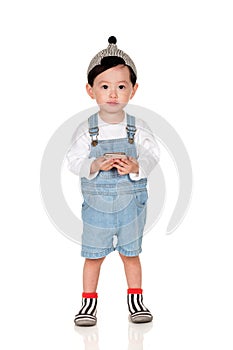 A studio portrait of a yoaEast Asian man looking at cellphone Studio portrait of young childung child sitting on an East Asian man