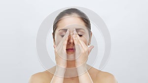 Studio portrait of young, beautiful and natural blond woman applying skin care cream. Face lifting, cosmetics and make