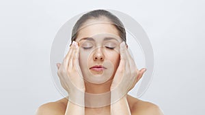 Studio portrait of young, beautiful and natural blond woman applying skin care cream. Face lifting, cosmetics and make