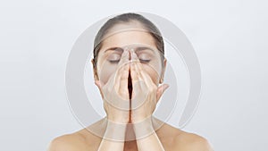 Studio portrait of young, beautiful and natural blond woman applying skin care cream. Face lifting, cosmetics and make