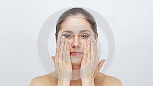 Studio portrait of young, beautiful and natural blond woman applying skin care cream. Face lifting, cosmetics and make