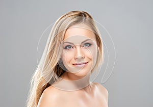 Studio portrait of young, beautiful and natural blond woman over grey background. Face lifting, plastic surgery photo