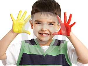 Studio Portrait Of Young Boy With Painted Hands