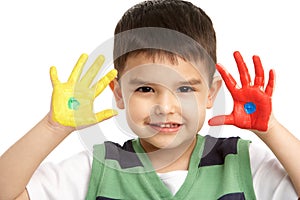 Studio Portrait Of Young Boy With Painted Hands