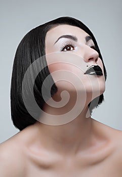 Studio portrait of young brunette with black lips