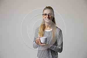 Studio Portrait Of Young Businesswoman Drinking Coffee