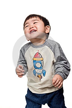 Studio portrait of young child building smile in white background