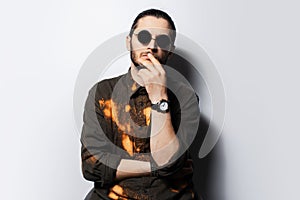 Studio portrait of young confident thoughtful man on white background