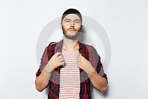 Studio portrait of young cool guy in red casual clothes on white background.