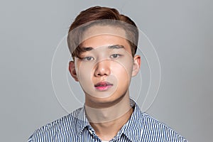 Studio portrait of a young East Asian man in distress