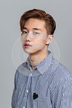 Studio portrait of a young East Asian man in distress