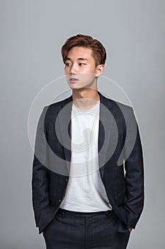 Studio portrait of a young East Asian man looking up