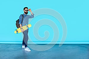 Studio portrait of young fashionable hipster man posing