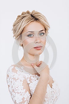 Studio portrait of a young girl of the bride with professional wedding makeup.