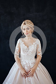 Studio portrait of a young girl of the bride with professional wedding makeup.