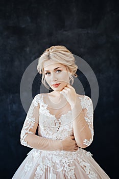 Studio portrait of a young girl of the bride with professional wedding makeup.