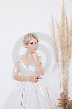 Studio portrait of a young girl of the bride with professional wedding makeup.