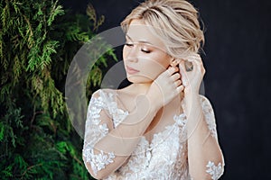 Studio portrait of a young girl of the bride with professional wedding makeup.