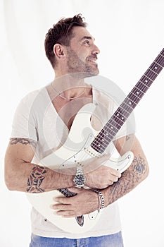 Studio portrait of young guitarist