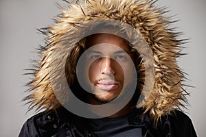 Studio Portrait Of Young Man Wearing Winter Coat