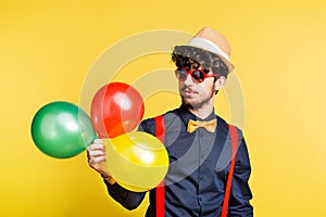 Studio portrait of a young man on a yellow background.