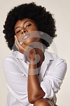 Studio portrait of a young stunning African American woman with a beautiful afro. Confident black female model showing