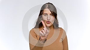 Studio portrait of young woman shaking her figner and saying No. Concept of ban, prohibition and taboo