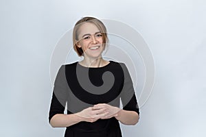 Studio portrait of a young woman with a wide smile and narrowed