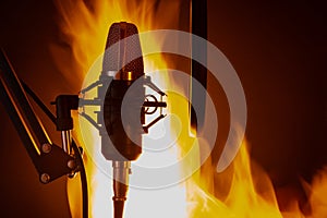 Studio professional microphone on the background of fire, effective photo