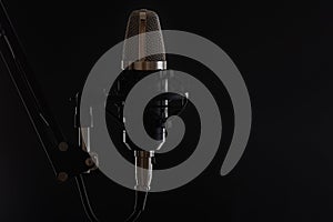 Studio professional microphone on a black background, vocals, streaming, sound equipment, sound recording