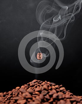 Studio, roasted coffee beans and smoke aroma for organic diet, flavor and black background. Art, seeds and texture of