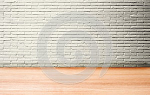 Studio room of white brick wall and wooden floor.