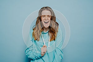 Studio shit of happy laughing beautiful teenage girl with eyes closed