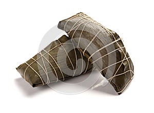 Studio shoot of two wrapped Chinese ZongZi on white for Dragon Boat Festival