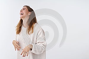 Studio shot amused happy attractive modern woman having fun laughing joking friendly company raising head chuckling lmao photo