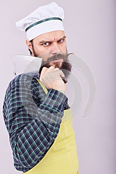 Studio shot of an angry bearded man holding a butcher knife