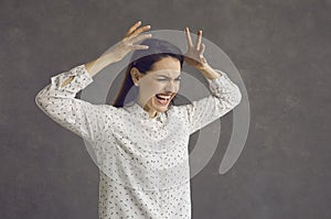 Studio shot of an angry stressed young woman irritated by work and life problems