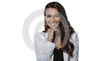 Studio shot of attractive woman with toothy smile standing at isolated white background