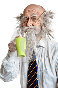 Studio shot of bald elegant oldman with cup