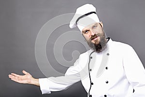 Studio shot of a bearded chef invinting you in