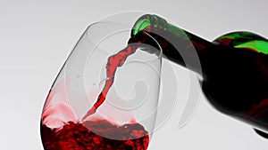 Studio shot of beautiful goblet isolated on white background in studio. Close up shot pouring red wine from bottle neck