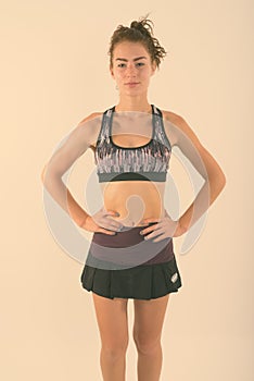 Studio shot of beautiful teenage girl standing while posing ready for sports and exercise against white background