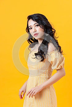 Studio shot of blithesome girl isolated on yellow background