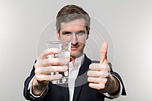 Studio shot of businessman with a glas of sparkling water